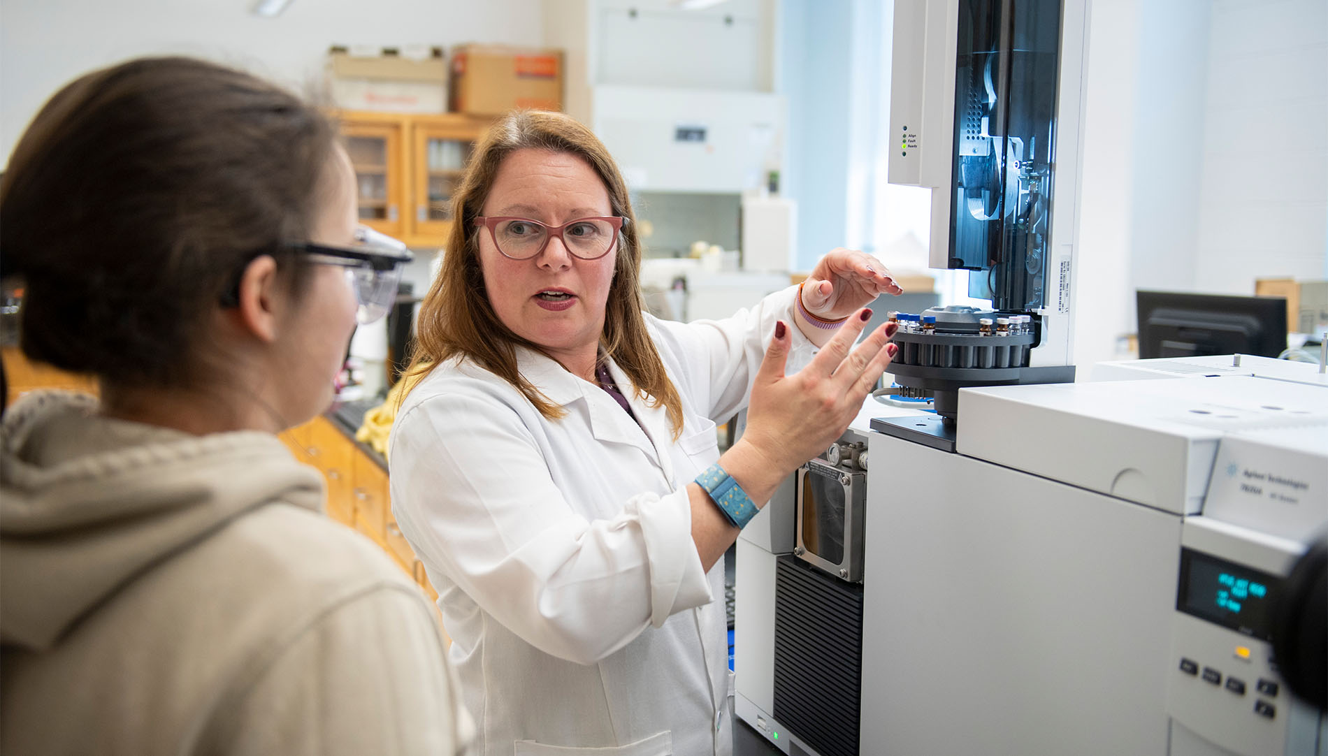 Student and professor in science laboratory